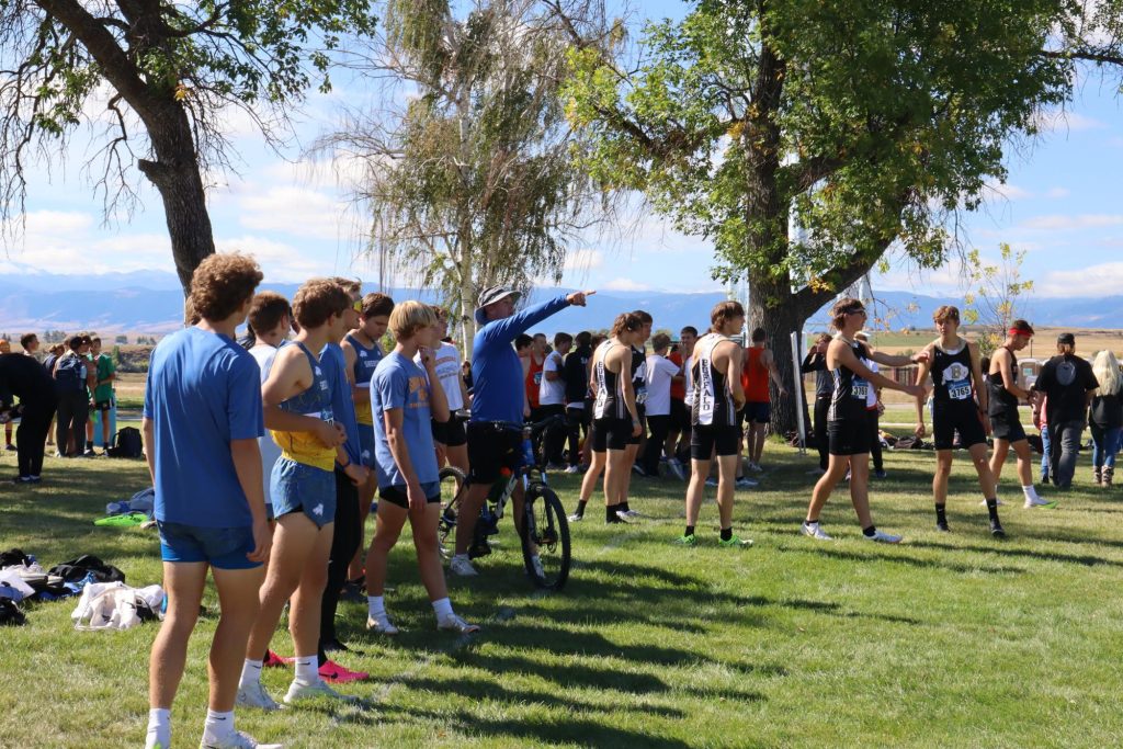 SHS Cross Country coach Art Baures gives the Boys Varsity team some final tips before their race at the VA Hospital on Sept. 21. (Zane Doyle)
