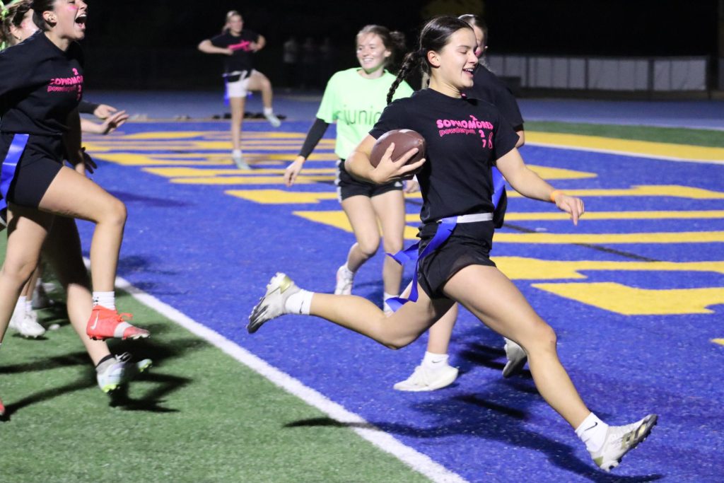 Sophomore Hannah Mowry scores a touchdown at the powderpuff football games (Brian Rizer) | SHS Ock