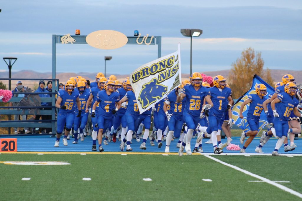 SHS Bronc football team rushes the field at the beginning of the homecoming game. (Brian Rizer) | SHS Ocksheperida