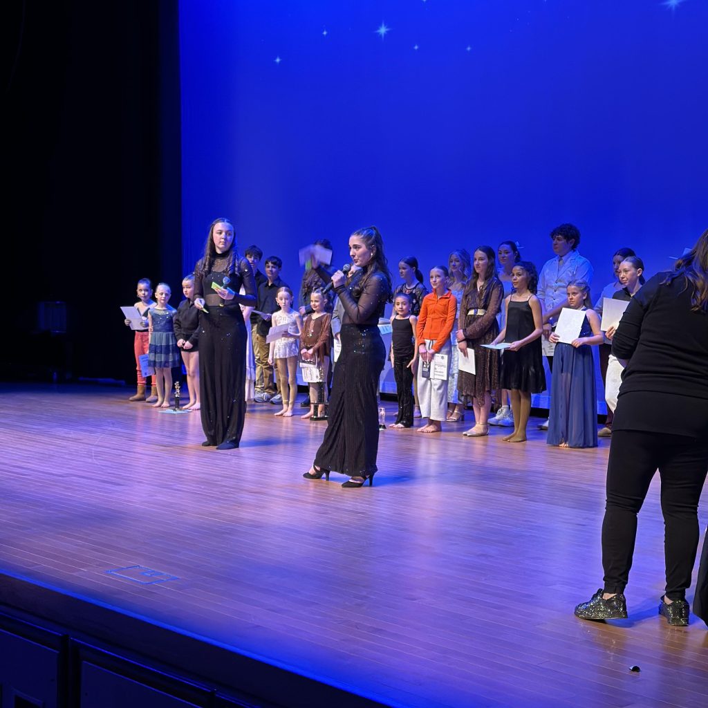 Masters of Ceremony, Joee Kahm and Lucy Broersma, announce the winner of “Stars of Tomorrow.” (Courtesy Dina Blanchard)