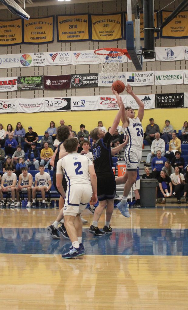 Junior Forward Nate Minor goes for a put-back layup. (Courtesy Ravin Carter)